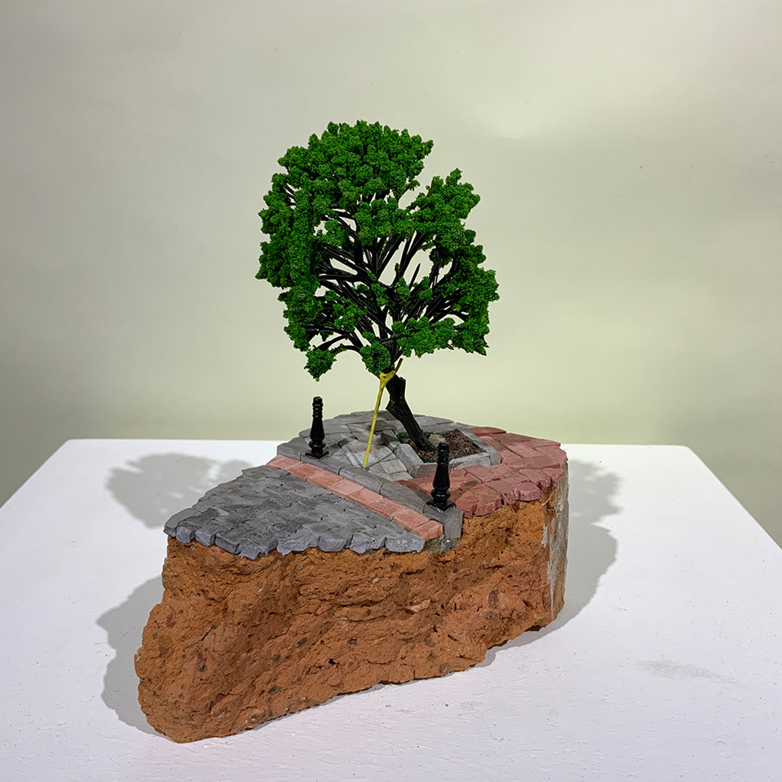 A miniature sculture of a propped up tree from On the Rubble of our Ancestors
