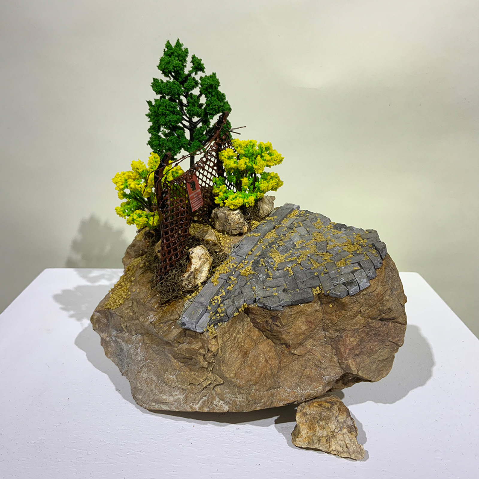 A miniature sculpture of broken fence from On the Rubble of our Ancestors